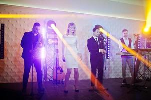 Musicial music live band performing on a stage with different lights. photo