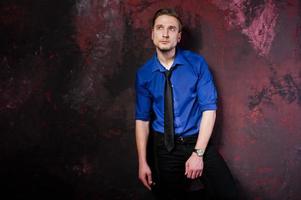 Studio portrait of stylish man, wear on blue shirt and necktie. photo