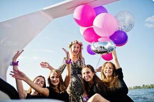 Girls having fun at yacht on hen party. photo