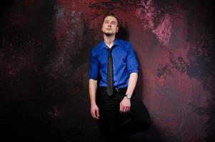 Studio portrait of stylish man, wear on blue shirt and necktie. photo