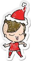 happy distressed sticker cartoon of a girl wearing santa hat vector