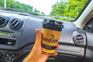 Playa del Carmen Quintana Roo Mexico 2022 Mexican andatti coffee from Oxxo holding while driving in Mexico. photo