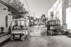 Holbox Quintana Roo Mexico 2021 Golf cart buggy cars carts muddy street village Holbox Mexico. photo