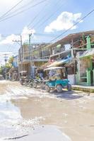 Holbox Quintana Roo Mexico 2021 Golf cart buggy cars carts muddy street village Holbox Mexico. photo
