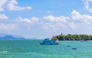 Ferry boats at Tai Kak Pier tropical sea Ranong Thailand. photo