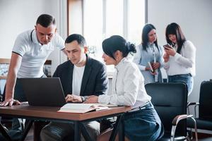 Concentrated at job. Business people and manager working on their new project in classroom photo