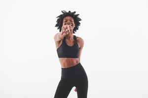 Come here. Young beautiful afro american woman in the studio against white background photo