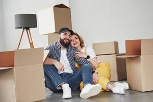 Active conversation. Happy couple together in their new house. Conception of moving photo