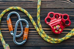Stronger that it looks. Isolated photo of climbing equipment. Parts of carabiners lying on the wooden table