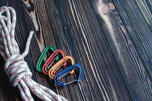 No one. Isolated photo of climbing equipment. Part of carabiner lying on the wooden table