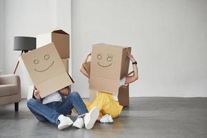 Artificial smiles. Happy couple together in their new house. Conception of moving photo