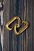 Good lighting. Isolated photo of climbing equipment. Parts of carabiners lying on the wooden table