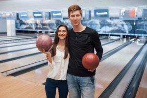 Modern people. Young cheerful friends have fun in bowling club at their weekends photo