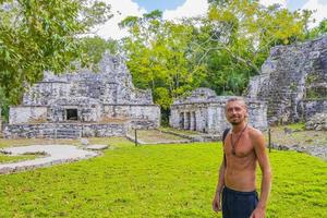 Tourist guide ancient Mayan site temple ruins pyramids Muyil Mexico. photo