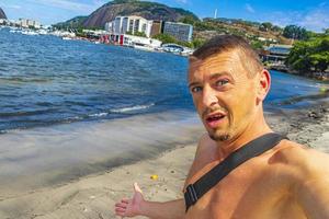 Tourist traveler takes selfie Sugarloaf mountain Rio de Janeiro Brazil. photo
