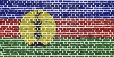 Flag of New Caledonia painted on a brick wall photo