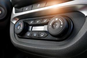 Air conditioning button inside a car. Climate control unit in the new car. Modern car interior details. Car detailing. Selective focus photo