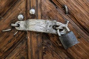 the old lock on the wooden brown door photo