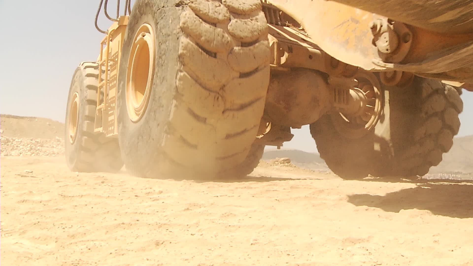 Big wheel excavator. Carrying tons of cargo. Construction work