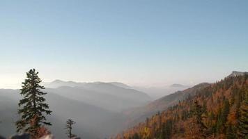 Cloudy mountains and forest in autumn. Wonderful view of clouds and colorful trees in autumn. video