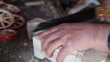 Wood carving. Wooden craftsmanship. Cutting wood with a saw. video