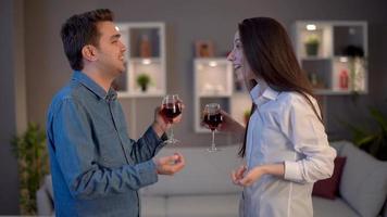 Young people who drink alcohol are chatting. Young people drinking wine standing up are in a conversation. video