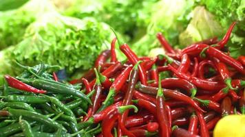 Red and green peppers. Red and green chillies available on the counter. video