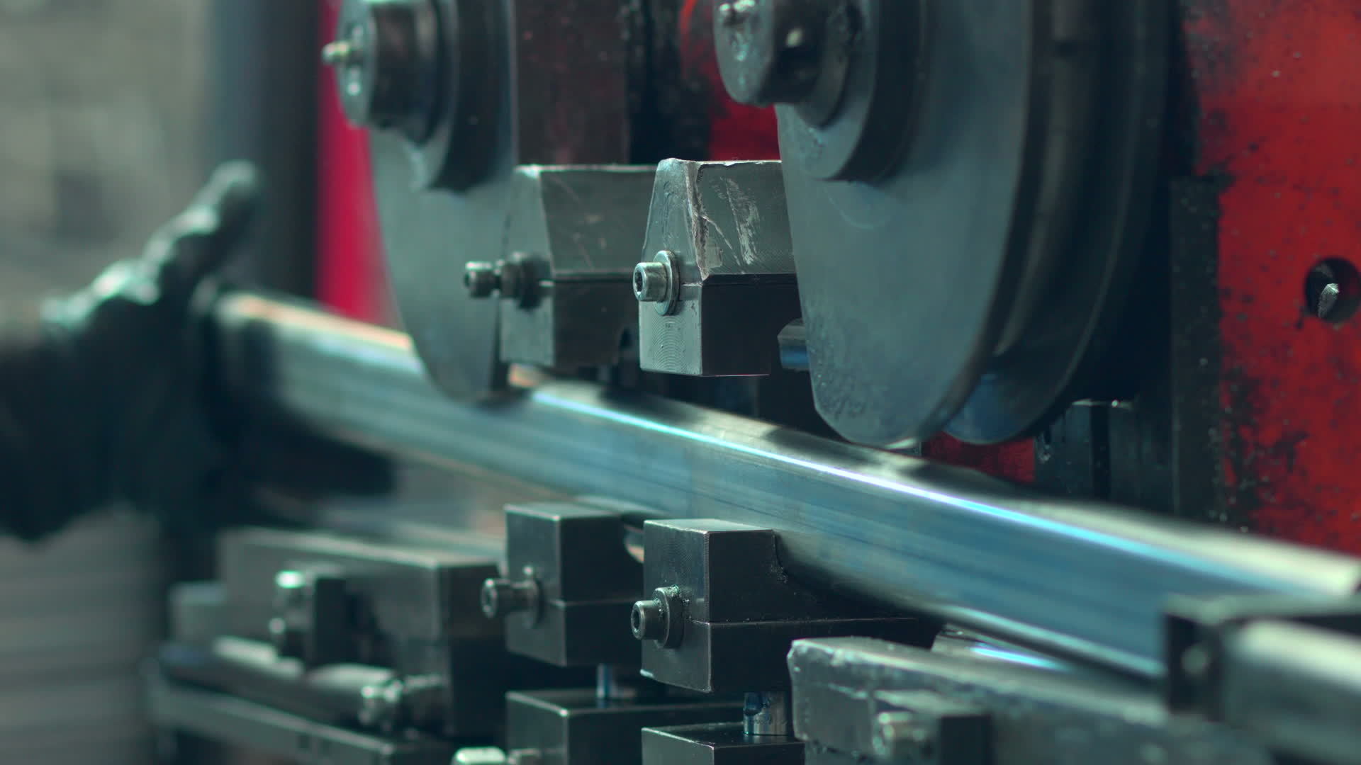 A bending machine operator bends a sheet metal workpiece on a CNC