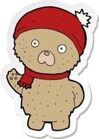 sticker of a cartoon teddy bear in winter hat and scarf vector