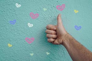 hand on the blue wall with hearts shapes, valentines's day photo