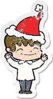 distressed sticker cartoon of a happy boy wearing santa hat vector