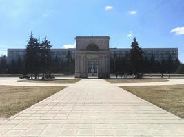 Republic of Moldova, city Chisinau, 2022 - Panoramic view of the Triumphal Arch with the Government building in the background photo