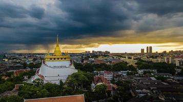 Golden Mountain  Wat Saket Ratcha Wora Maha Wihan popular Bangkok tourist attraction , Landmarks of bangkok Thailand . In the rain before , topview photo