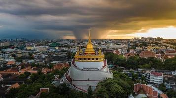 Golden Mountain  Wat Saket Ratcha Wora Maha Wihan popular Bangkok tourist attraction , Landmarks of bangkok Thailand . In the rain before , topview photo