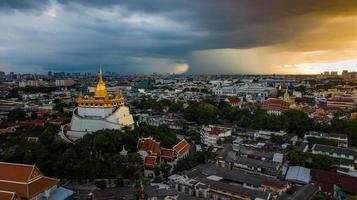 Golden Mountain  Wat Saket Ratcha Wora Maha Wihan popular Bangkok tourist attraction , Landmarks of bangkok Thailand . In the rain before , topview photo