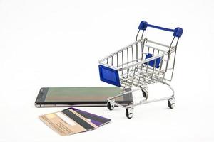 smart phone with shopping cart on white background , Means shopping online photo