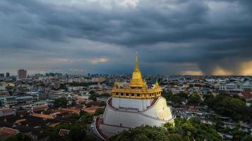 Golden Mountain  Wat Saket Ratcha Wora Maha Wihan popular Bangkok tourist attraction , Landmarks of bangkok Thailand . In the rain before , topview photo