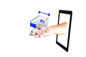 shopping cart in hand  with Tablet on white background photo