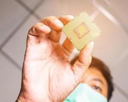 Take a picture of the angle of the cpu insertion. There is a picture of a person wearing a mess. Blurred and clear that the cpu has orange light, like in a laboratory. photo