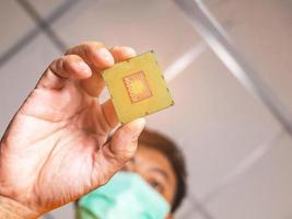 Take a picture of the angle of the cpu insertion. There is a picture of a person wearing a mess. Blurred and clear that the cpu has orange light, like in a laboratory. photo
