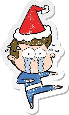 distressed sticker cartoon of a crying dancer wearing santa hat