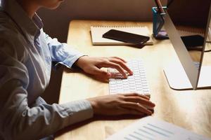 businesswoman working on desk using laptop for check data of finance in office photo