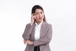 Asian business woman in formal suit is thinking something on white background. photo