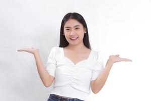 Portrait Asian woman is smiling and shows her hands to present something on the white background. photo