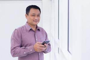 Asian business man is holding smartphone photo