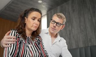 el esposo consuela a su trágica esposa con depresión en el dormitorio, la esposa y el esposo intentan resolver los problemas difíciles de la vida. foto