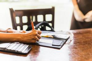 Woman signing slip payment credit card in restaurant. photo