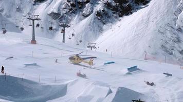 Rettungshubschrauber landet auf den Pisten und hilft Skifahrern in einem Skipark. Luftkrankenwagen in den Alpen. Rettungstransport. video