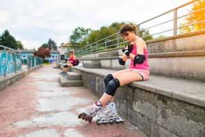 Girls are preparing to do rollerblading in the field photo