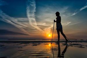 Nordic walking in the beach at sunrise photo